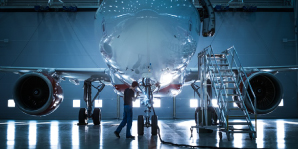 0424 Front-view-of-airplane-worker-examining-nose-of-aircraft-in-hangar